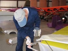 Technician finishing an aircraft fuselage inside the U-Fly-It hangar